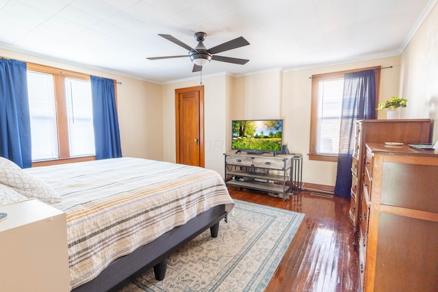 bedroom featuring ornamental molding, a ceiling fan, and hardwood / wood-style flooring