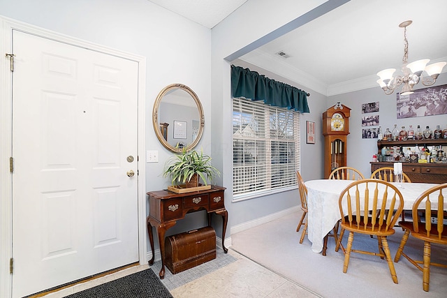 dining area with baseboards, visible vents, a chandelier, and ornamental molding