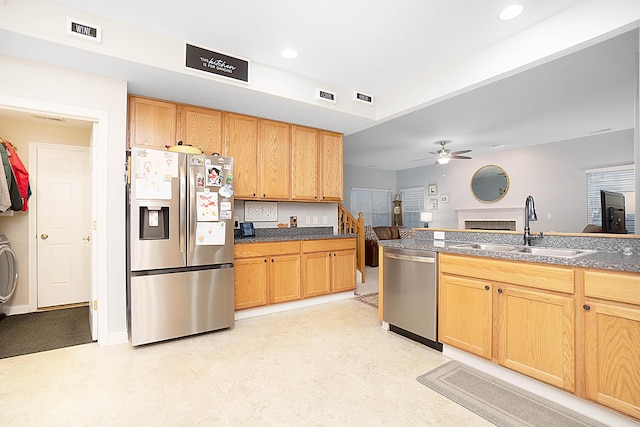 kitchen featuring visible vents, a ceiling fan, dark countertops, appliances with stainless steel finishes, and a sink