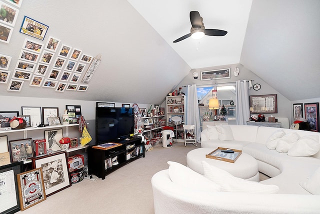 living area featuring a ceiling fan, carpet flooring, and vaulted ceiling