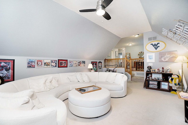 living area with visible vents, a ceiling fan, vaulted ceiling, stairway, and carpet