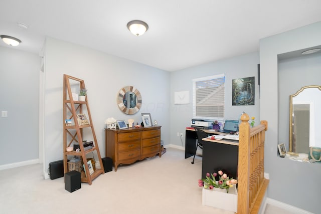 carpeted office space featuring baseboards