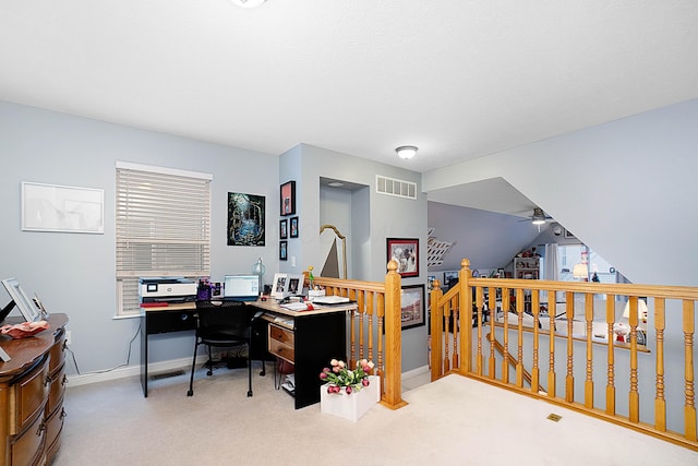 carpeted home office with ceiling fan, visible vents, and baseboards