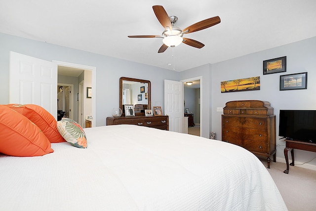 carpeted bedroom featuring connected bathroom, baseboards, and a ceiling fan