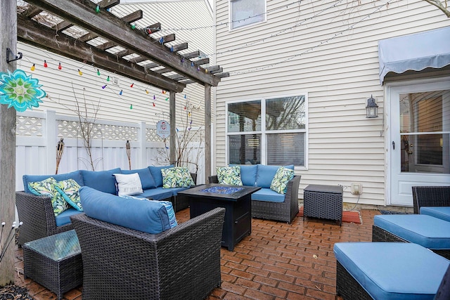 view of patio with fence, a pergola, and an outdoor living space with a fire pit