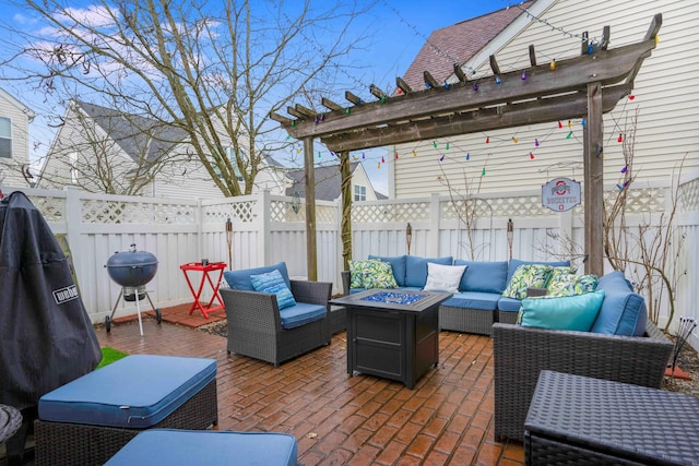 view of patio featuring an outdoor living space with a fire pit, a grill, a fenced backyard, and a pergola