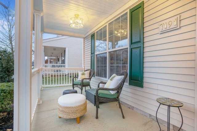 exterior space featuring plenty of natural light and a notable chandelier