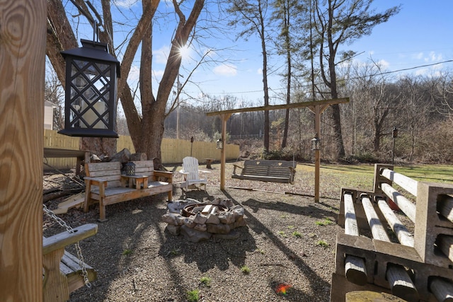 view of yard featuring a fire pit and fence