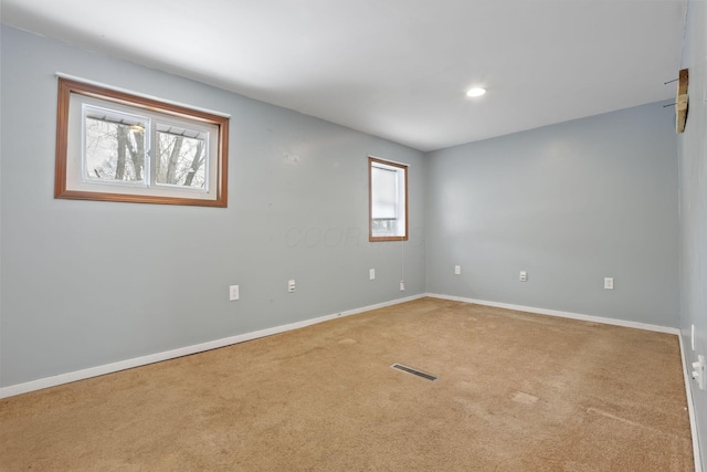 empty room with carpet, baseboards, visible vents, and recessed lighting