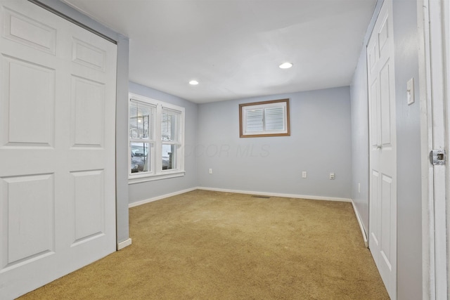 unfurnished bedroom featuring recessed lighting, light colored carpet, and baseboards