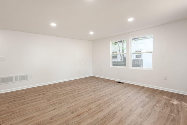 unfurnished room featuring recessed lighting, baseboards, visible vents, and light wood finished floors