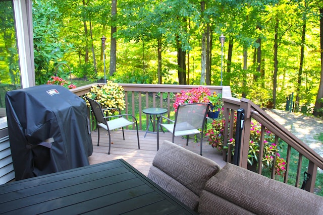 wooden terrace featuring a grill