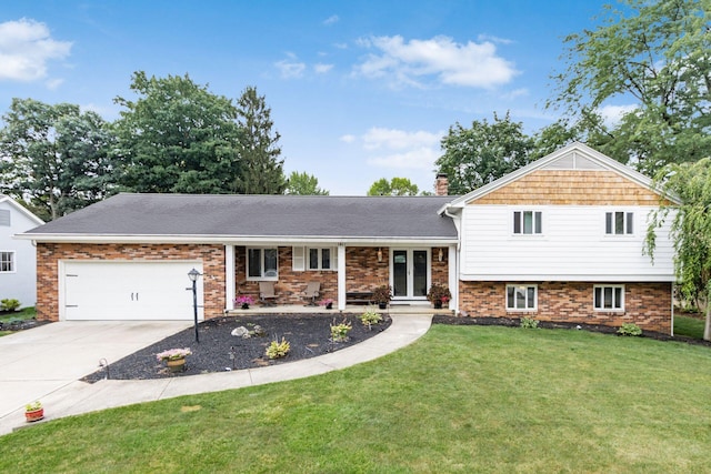 split level home with a garage, brick siding, driveway, and a front yard