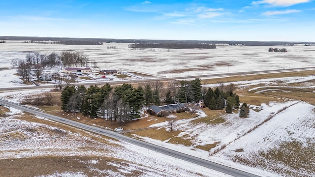 snowy aerial view featuring a rural view