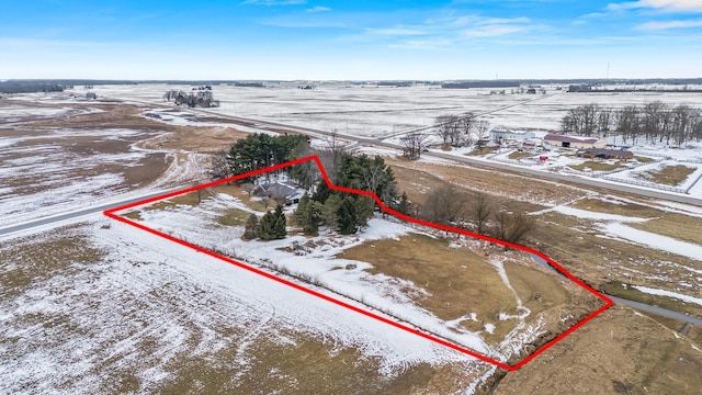 snowy aerial view featuring a rural view