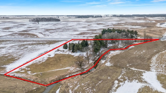 snowy aerial view featuring a rural view