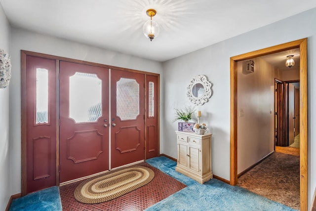 entryway featuring carpet flooring and baseboards