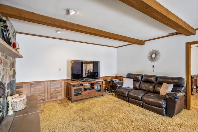 living room with light colored carpet, wainscoting, beamed ceiling, and visible vents