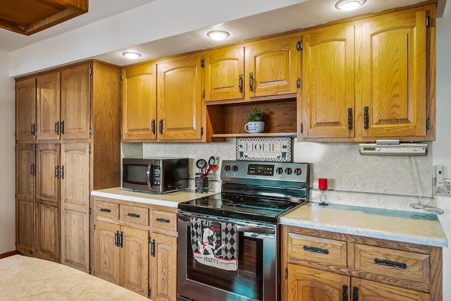 kitchen with brown cabinets, open shelves, stainless steel appliances, light countertops, and backsplash