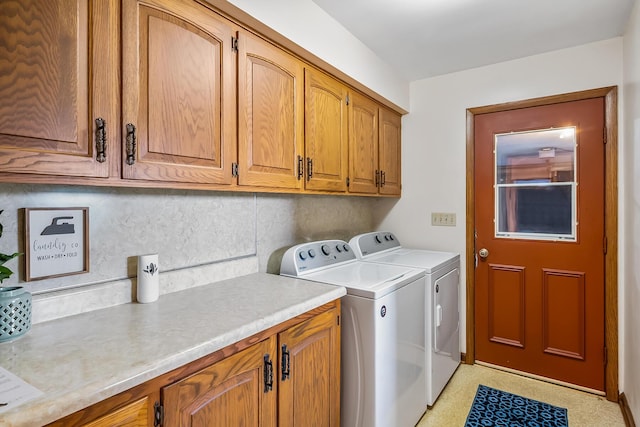 washroom with independent washer and dryer and cabinet space