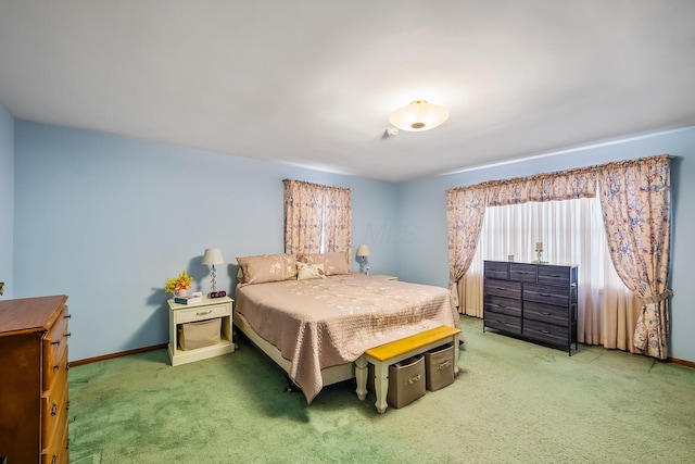 carpeted bedroom with baseboards