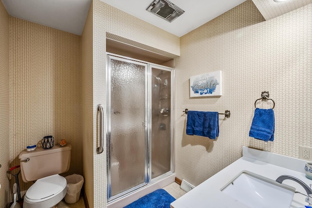 full bathroom with toilet, wallpapered walls, vanity, and a stall shower