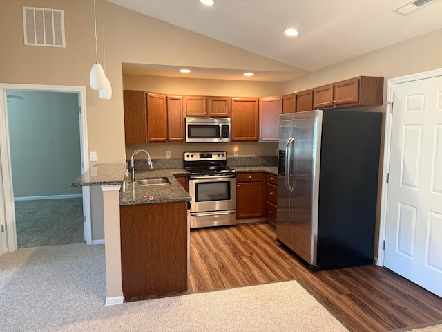 kitchen featuring a sink, visible vents, lofted ceiling, and appliances with stainless steel finishes