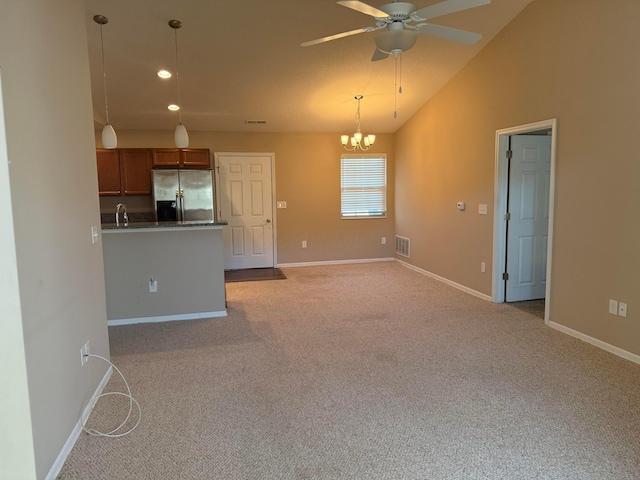 interior space with visible vents, brown cabinets, stainless steel refrigerator with ice dispenser, dark countertops, and light colored carpet