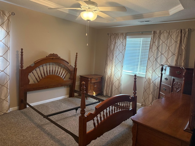 carpeted bedroom with visible vents, a raised ceiling, a textured ceiling, crown molding, and baseboards