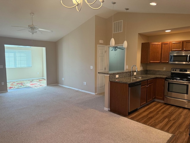 kitchen featuring visible vents, brown cabinets, a sink, appliances with stainless steel finishes, and a peninsula