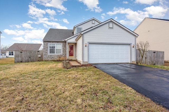 view of front of property featuring aphalt driveway, an attached garage, fence, stone siding, and a front yard