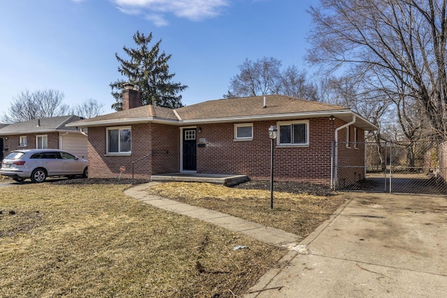 ranch-style home with a chimney, fence, a front lawn, and brick siding