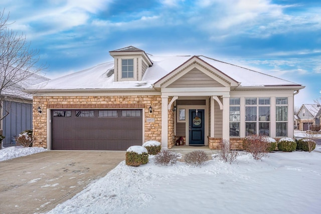 view of front of house featuring a garage, stone siding, and concrete driveway