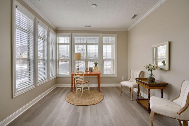 office space with baseboards, visible vents, wood finished floors, crown molding, and a textured ceiling