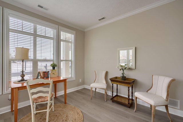 office area featuring light wood-style flooring and visible vents