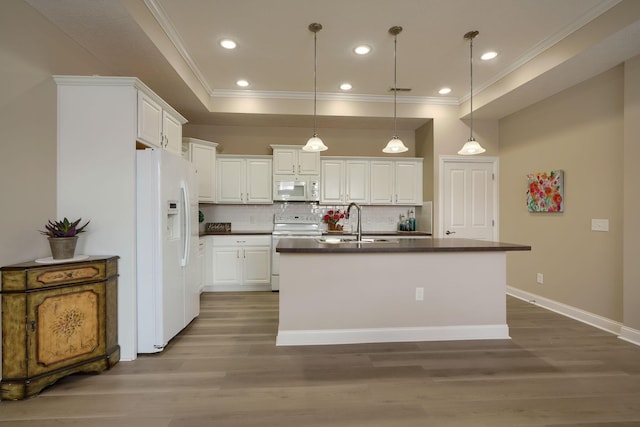 kitchen with hanging light fixtures, white appliances, and white cabinets