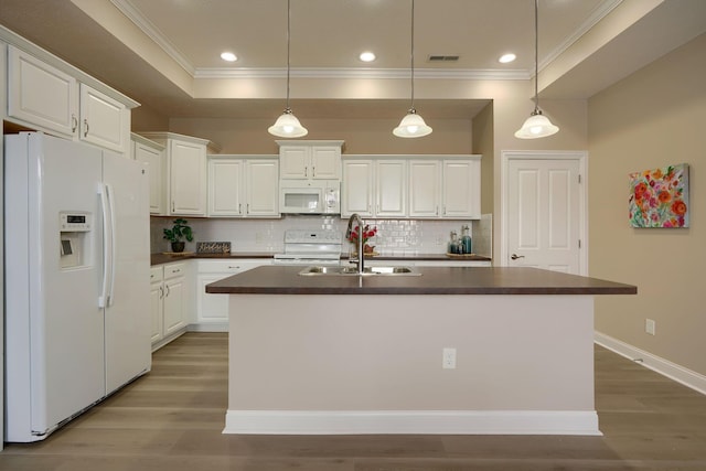 kitchen featuring white appliances, dark countertops, and white cabinets