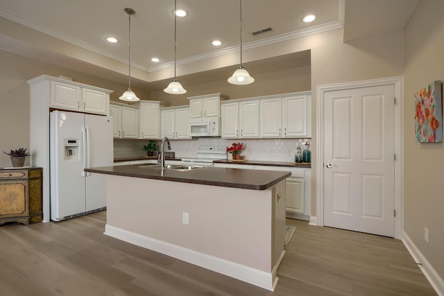 kitchen featuring dark countertops, white appliances, and white cabinets