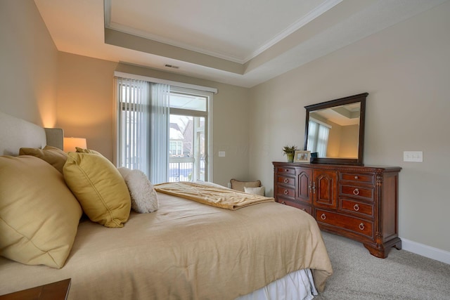 bedroom featuring a raised ceiling, light colored carpet, visible vents, and baseboards