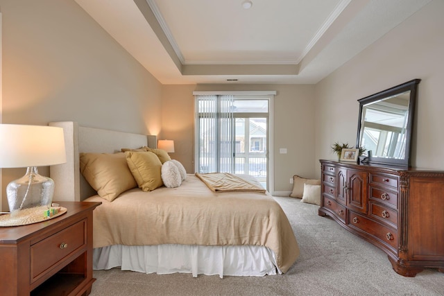 bedroom featuring access to exterior, a tray ceiling, ornamental molding, and light colored carpet