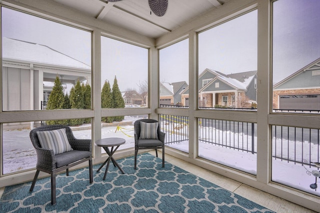 sunroom featuring ceiling fan