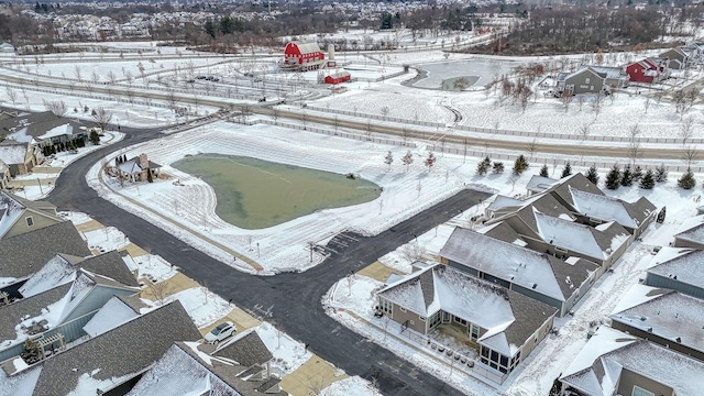 snowy aerial view with a residential view