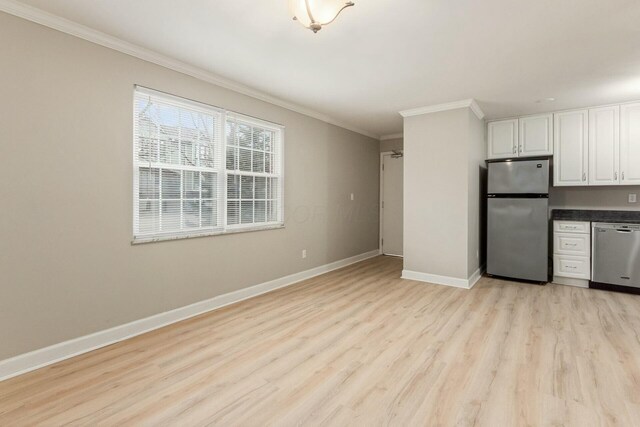 kitchen with light wood-style flooring, white cabinetry, appliances with stainless steel finishes, crown molding, and baseboards