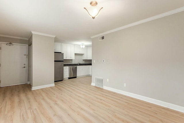 unfurnished living room with light wood-style floors, visible vents, crown molding, and baseboards