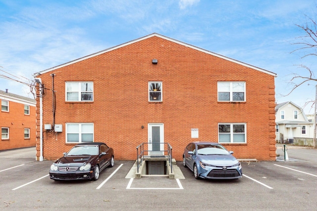 view of property featuring uncovered parking