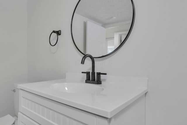 bathroom featuring a textured ceiling and vanity