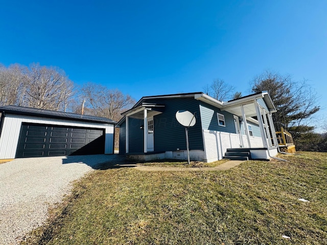 view of front facade featuring a garage, a front yard, an outdoor structure, and a porch