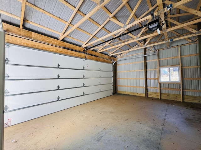 garage with metal wall and a garage door opener