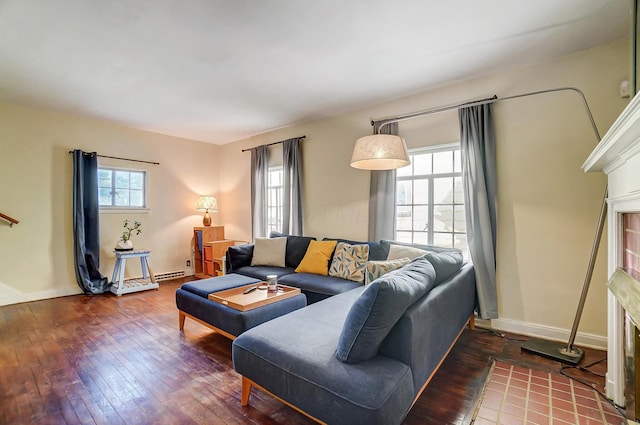 living area featuring hardwood / wood-style flooring, a fireplace, and baseboards