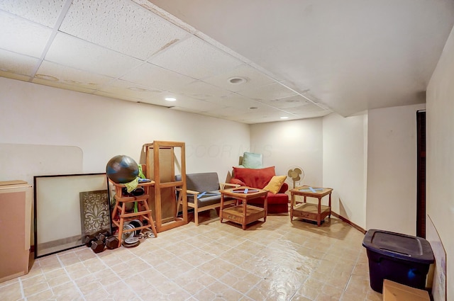 living area with a paneled ceiling, baseboards, and recessed lighting